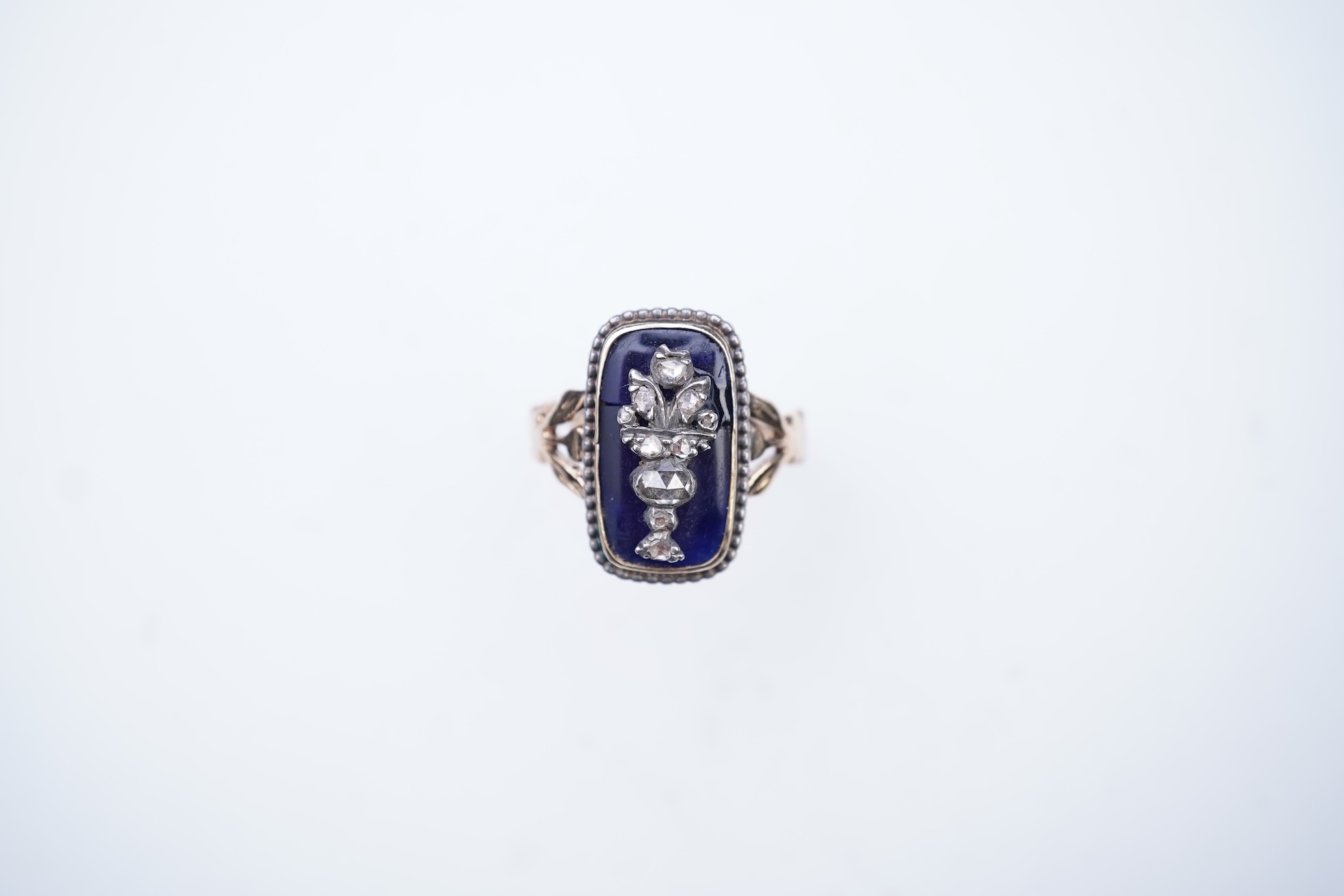A diamond and blue glass ring